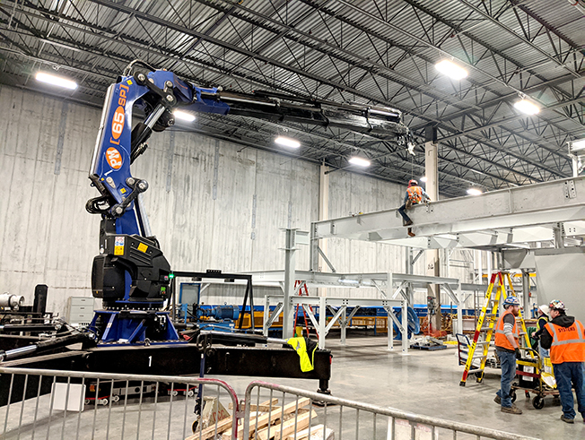 Knuckle boom cranes extend reach.