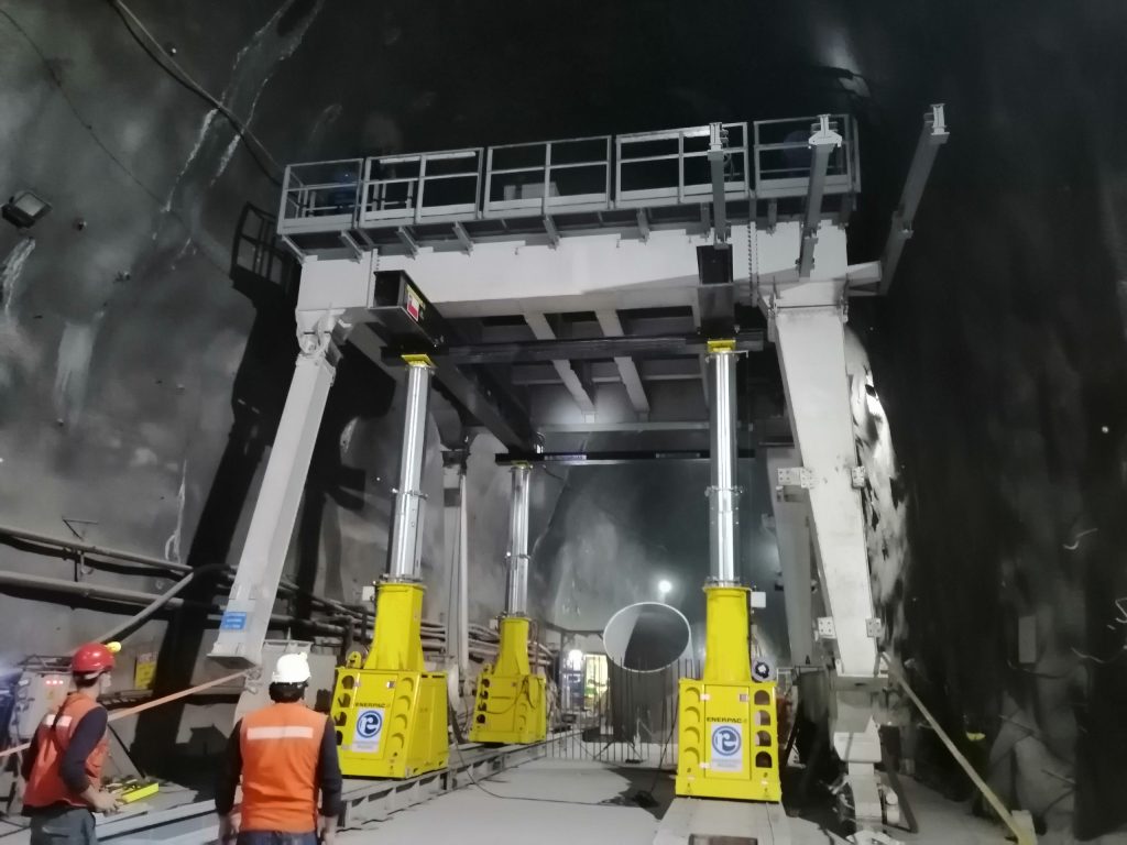 An Engineered Rigging Hydraulic Gantry is used to lower a crane inside of a tunnel at the Malto Aipo Hydropower Plant.
