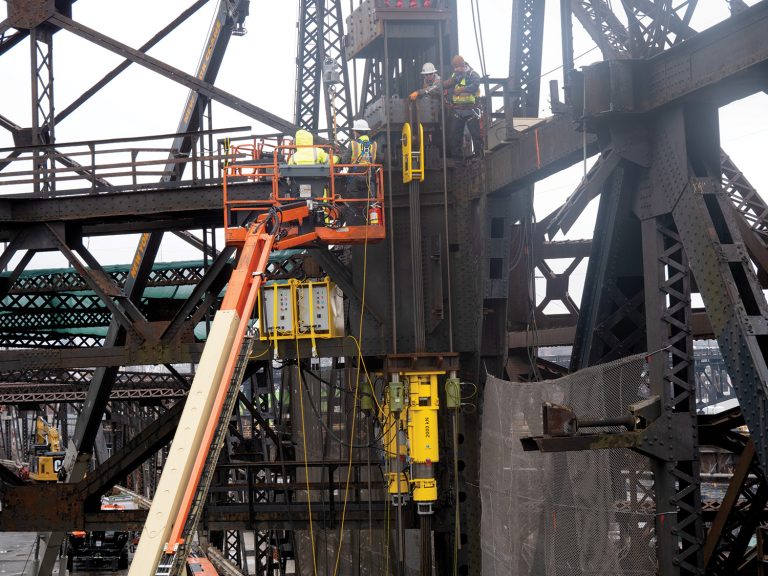 Bridge repair project utilizing strand jacks and hydraulic cylinders.