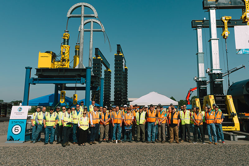 Attendees and Engineered Rigging team members pose for a photo in the equipment yard at the 2025 Heavy Lifting Equipment Showcase in Russellville, Arkansas.
