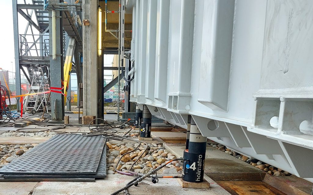 Enerpac ring climbing cylinders shown hoisting a heavy piece of equipment on a project site.