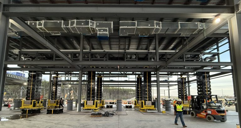 During construction of a pharmaceutical plant in North Carolina, eight jack-up systems are shown holding a 245,000 pound pipe rack in position at 22 feet elevation.
