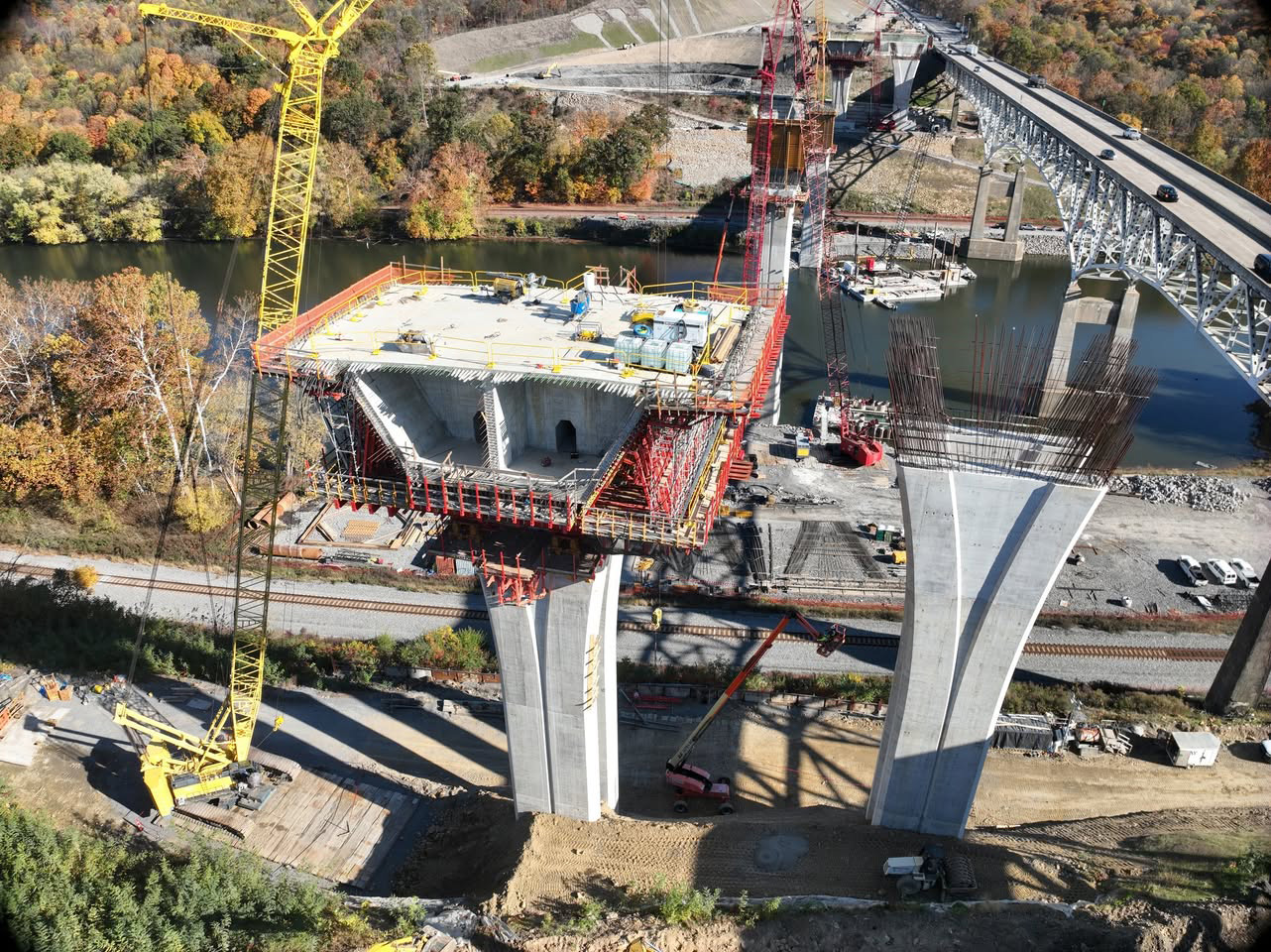 A bridge pier with formwork and scaffolding towers above the Beaver River.