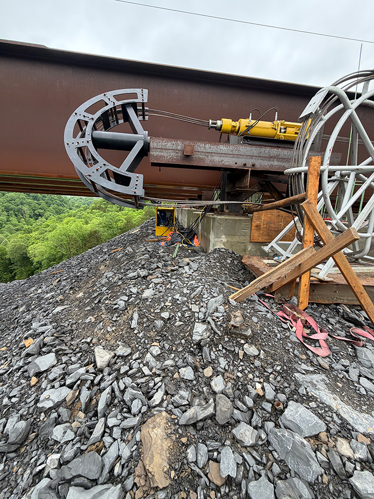 An Engineered Rigging strand jacks is positioned along a bridge girder during construction of the Salt Lick Creek Bridge in Kentucky.